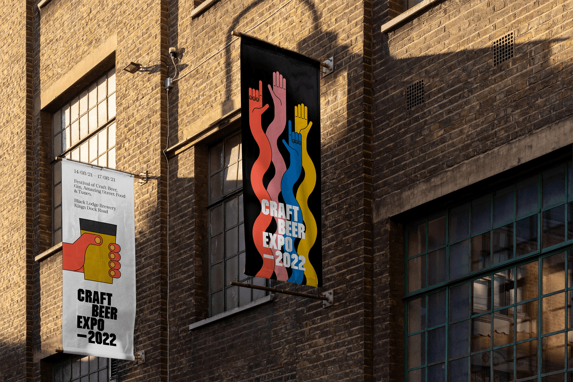 Craft Beer Expo 2022 banners with colourful raised hands hanging on a brick warehouse wall