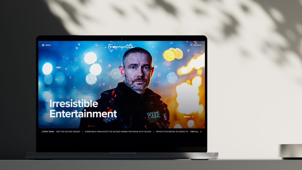 Laptop showing a website homepage headlined ‘Irresistible Entertainment’