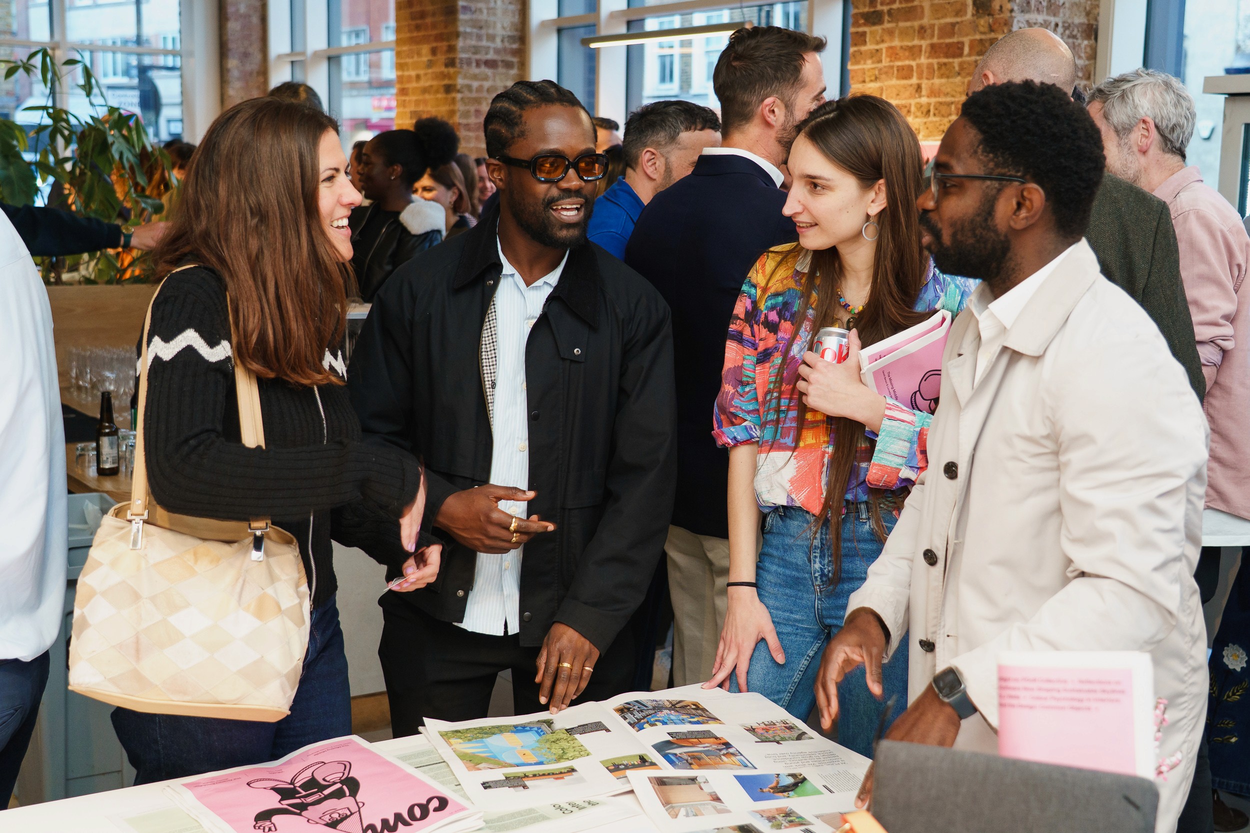 Guests chat around a table of Common magazines at the Clerkenwell launch night