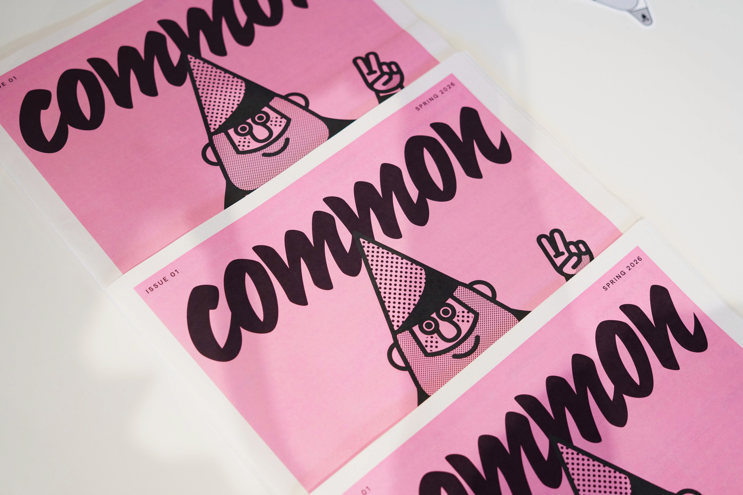 Pink printed covers of Common, a collaborative architecture anti-journal